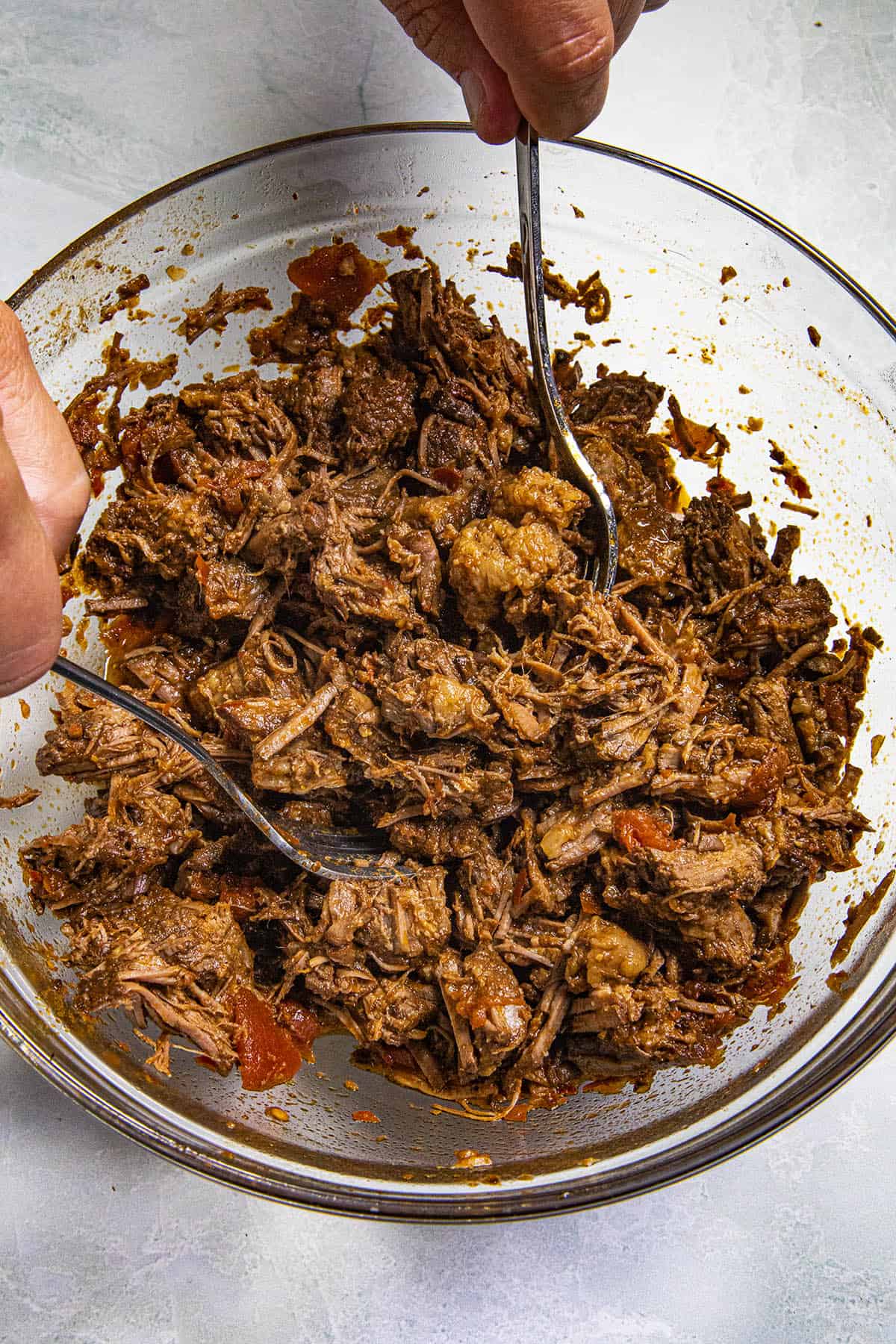 Shredding the Mexican Birria in a bowl