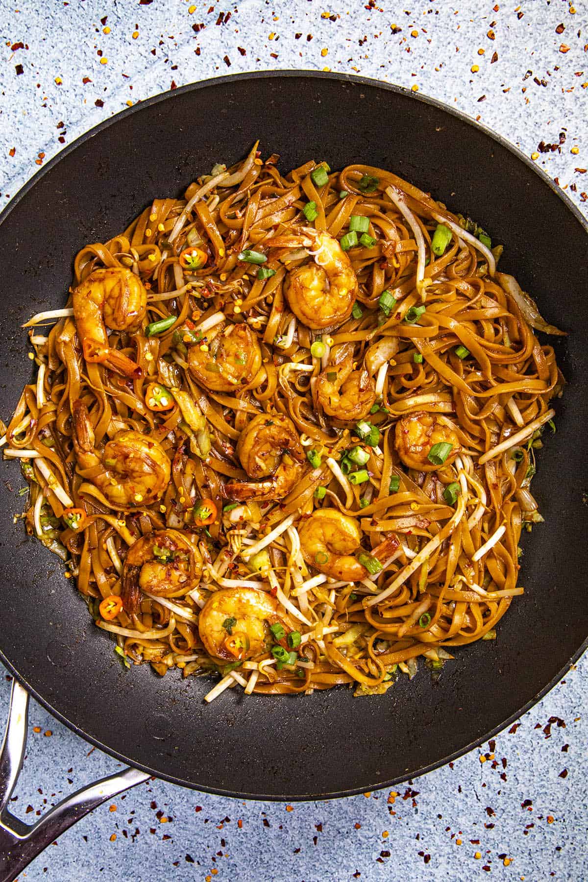 Mie Goreng, Indonesian stir fry noodles, in a pan with lots of shrimp