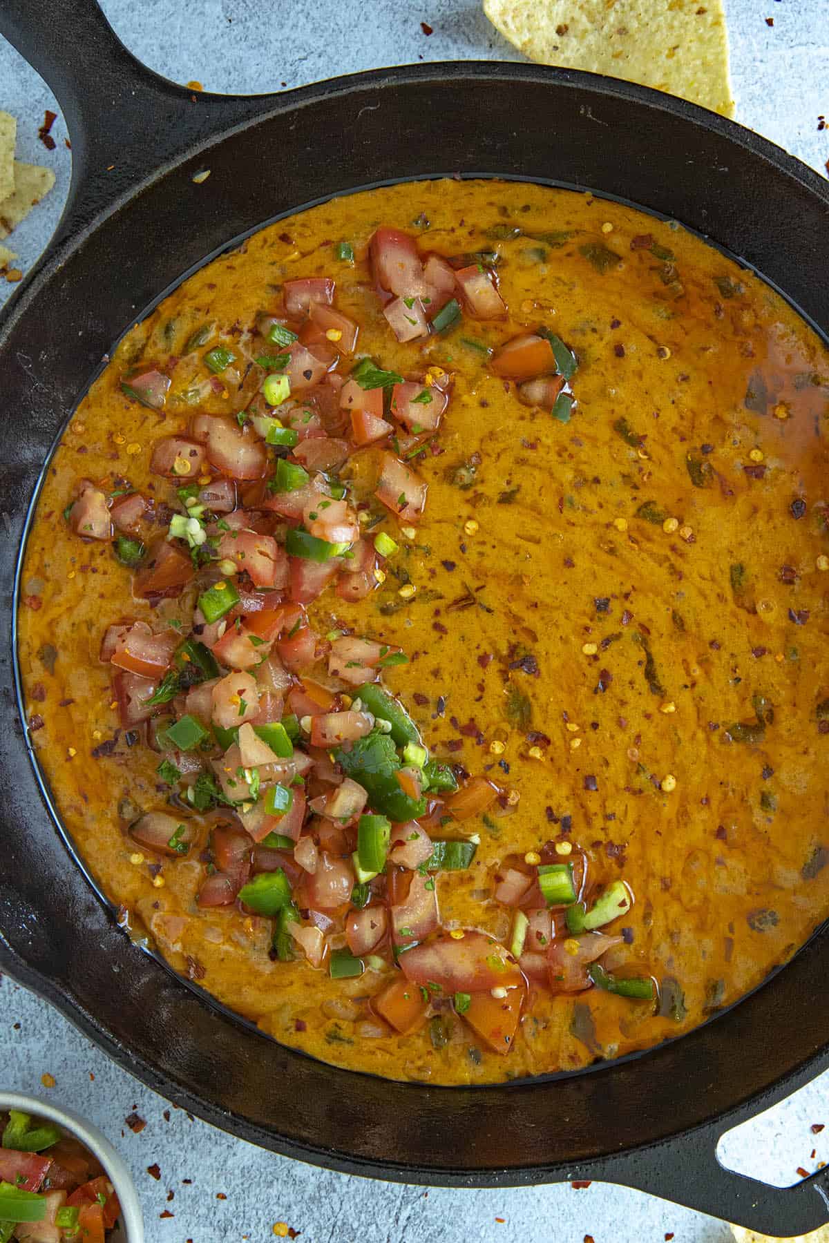 Gooey, cheesy Queso Fundido in a pan, ready to serve