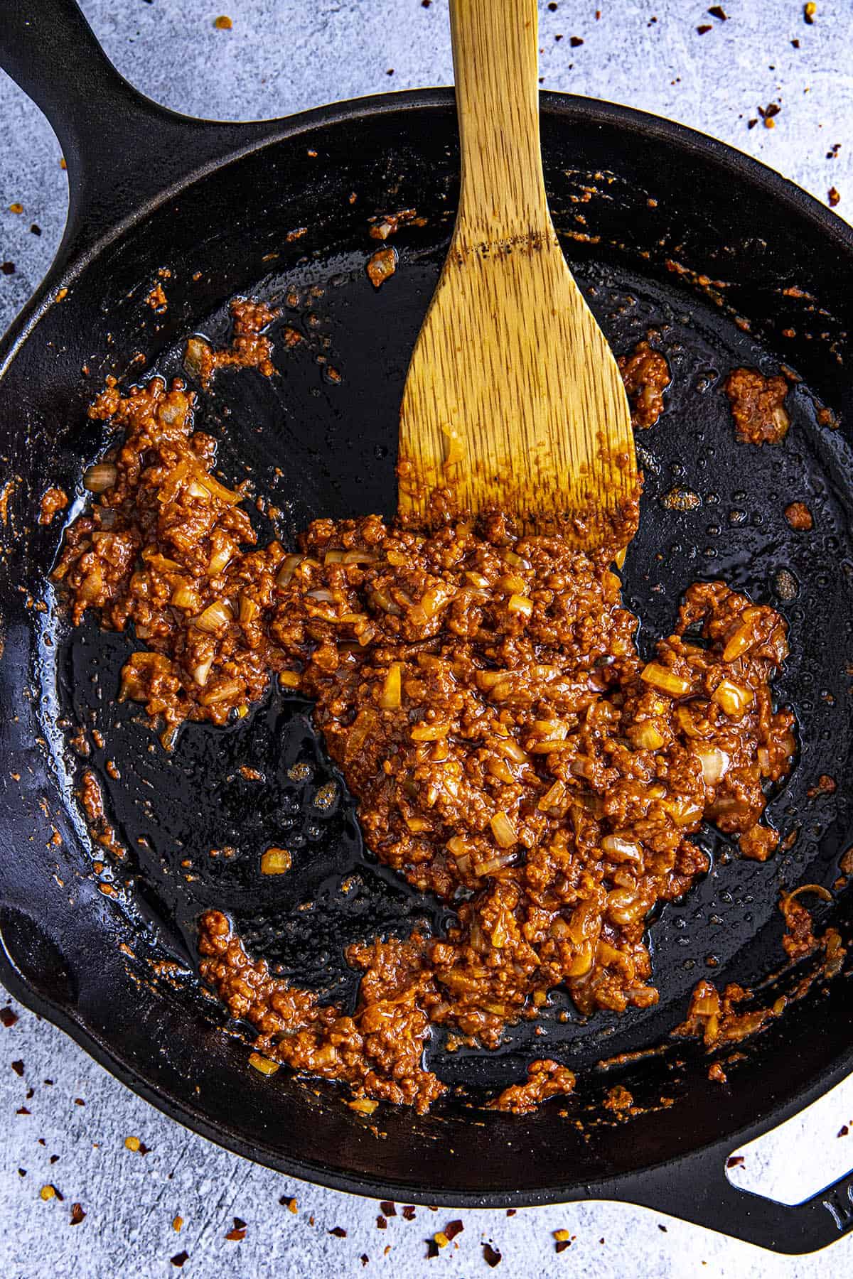 Cooking chorizo in a hot pan to make queso fundido