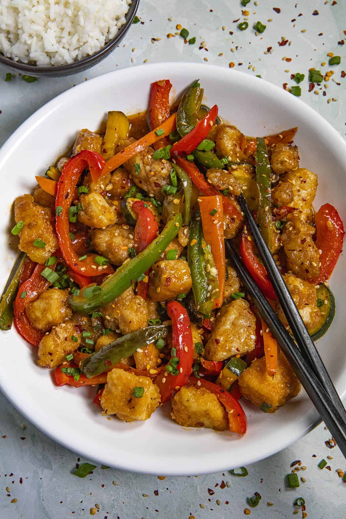 Spicy Hunan Chicken in a bowl with chopsticks