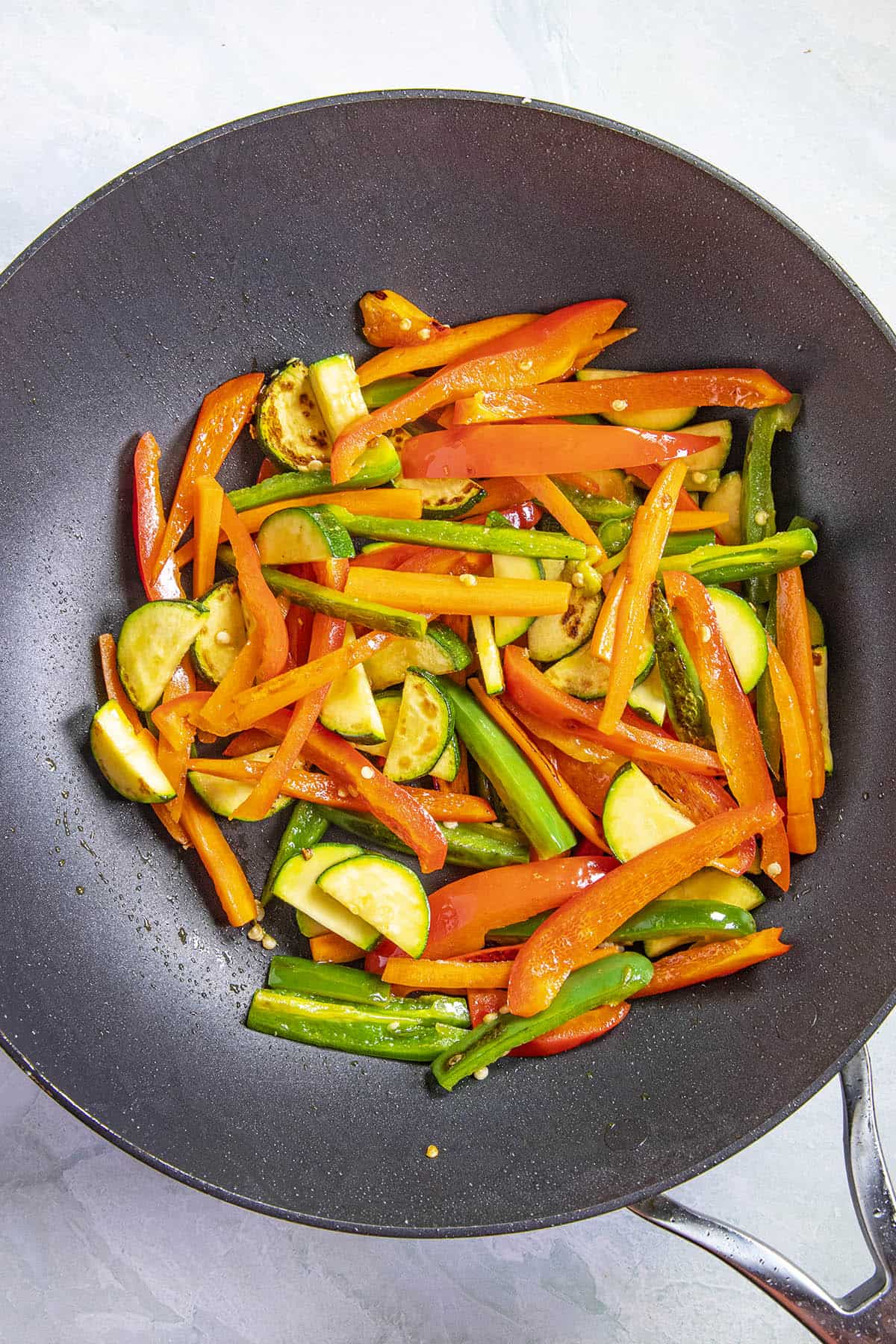 Adding the vegetables to the hot pan