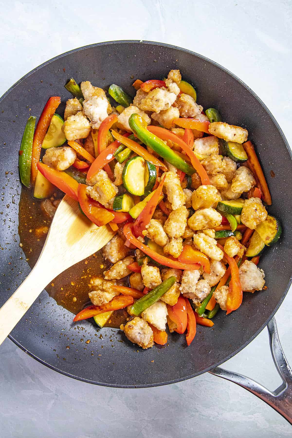 Mixing in the sauce to make hunan chicken