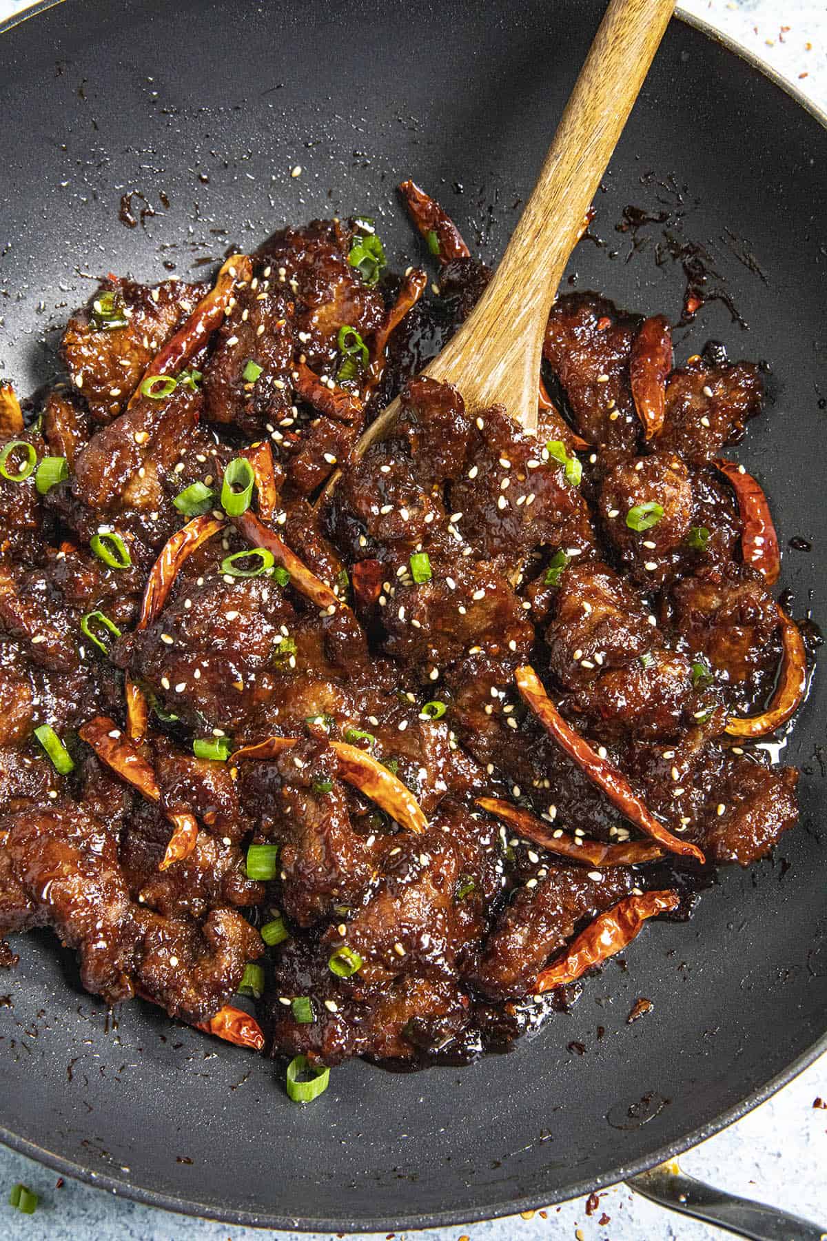 Mike scooping Mongolian Beef from the pan