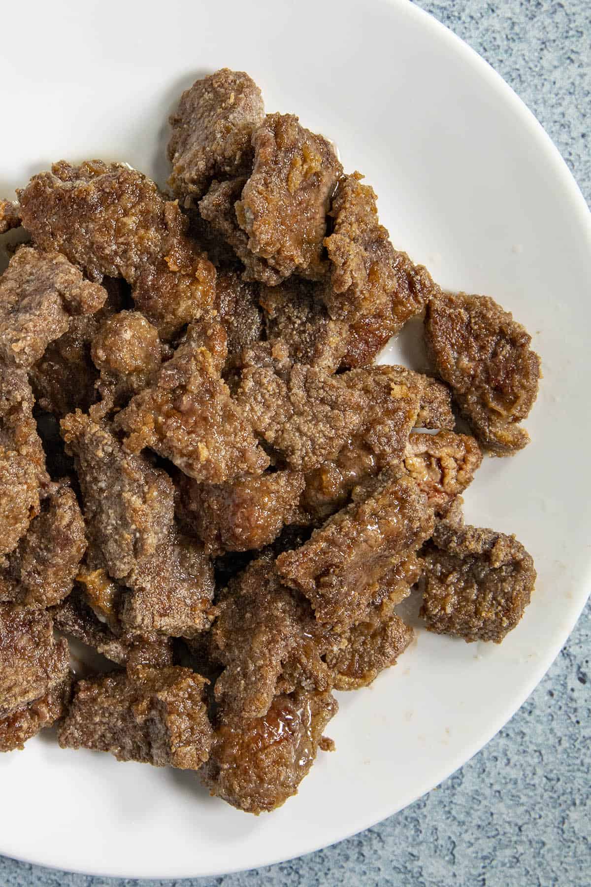 Fried beef on a plate for making Mongolian Beef