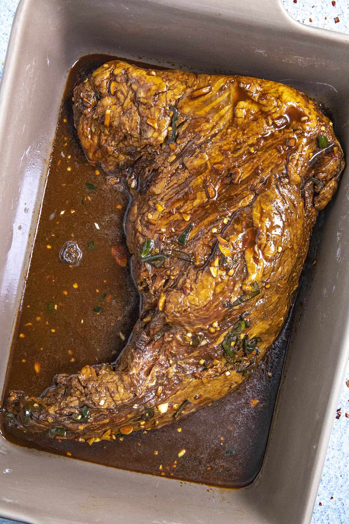 Tri tip marinating in a pan