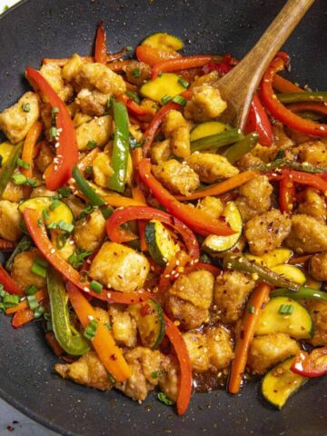 Mike stirring Hunan Chicken in a hot wok