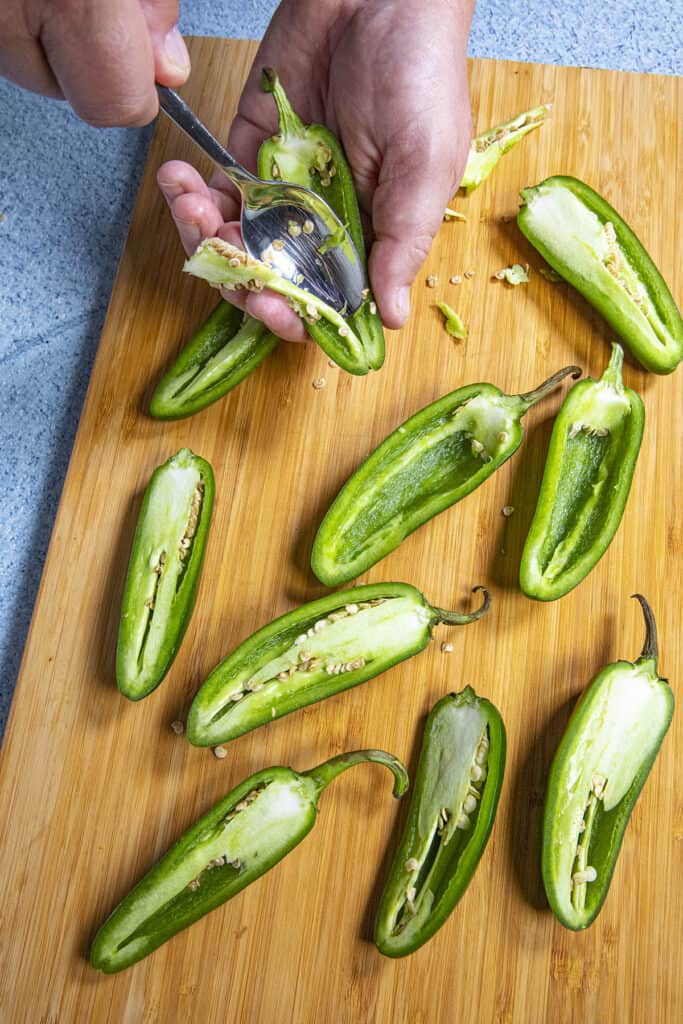 Coring out jalapeno peppers to make air fryer jalapeno poppers