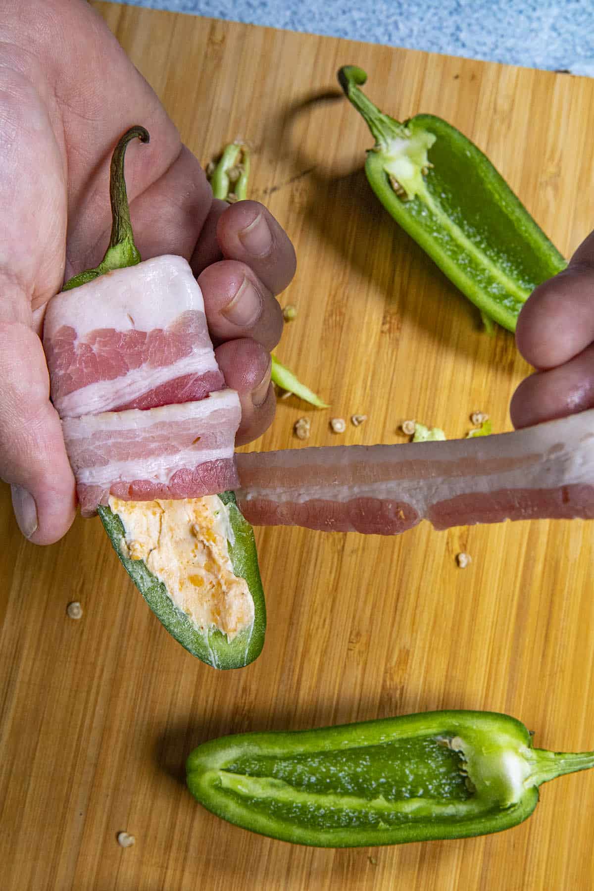 Wrapping jalapeno poppers in bacon