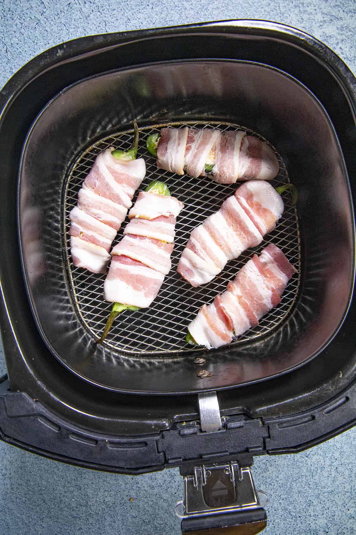 Air Fryer Jalapeno Poppers in the fry basket, ready for air frying