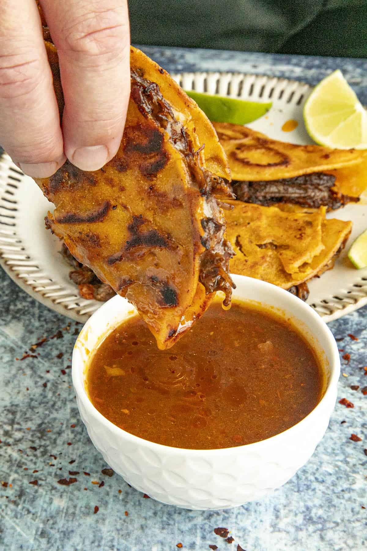 Mike dipping a Birria taco into consome