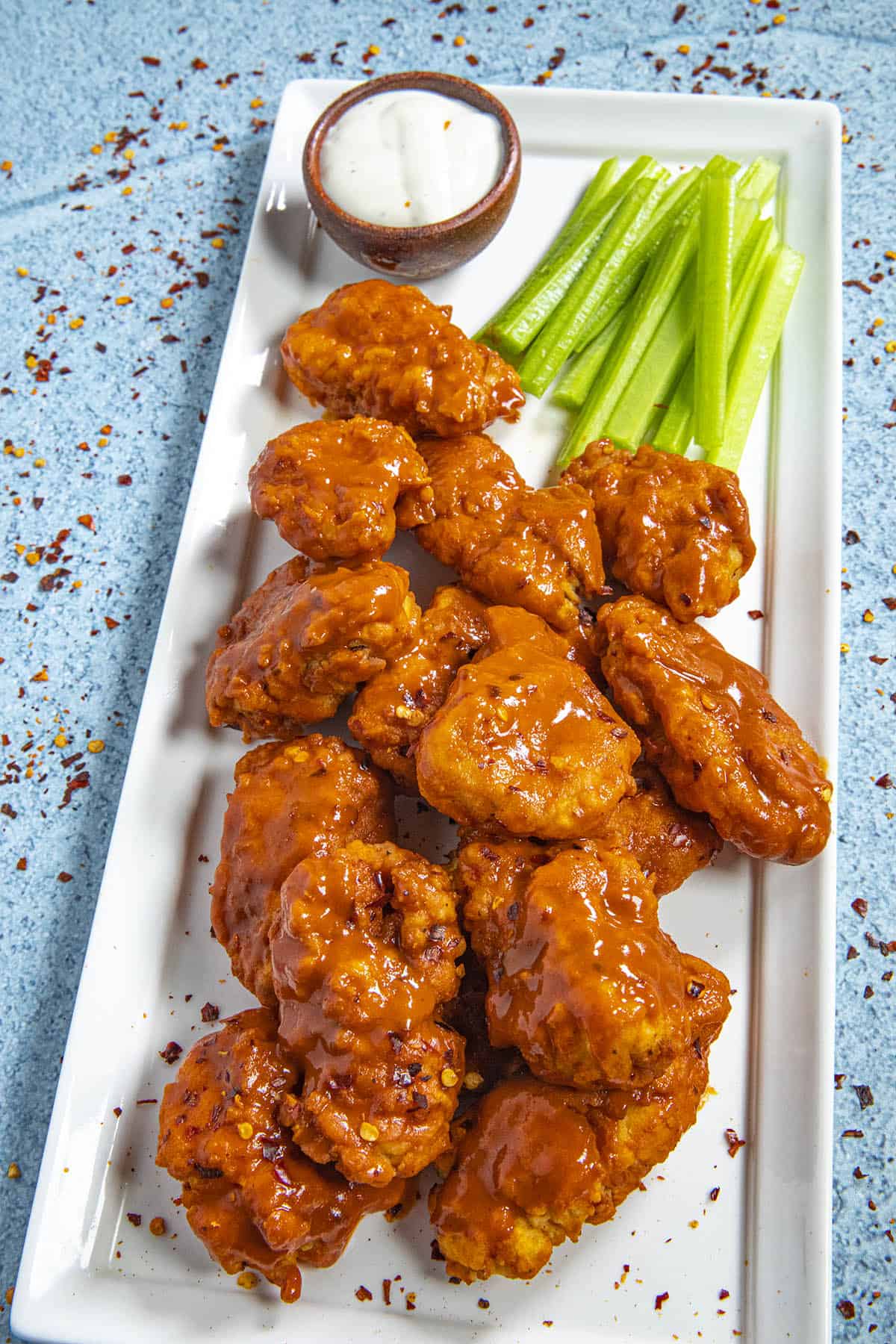 Spicy Boneless Buffalo Wings on a platter with blue cheese dressing
