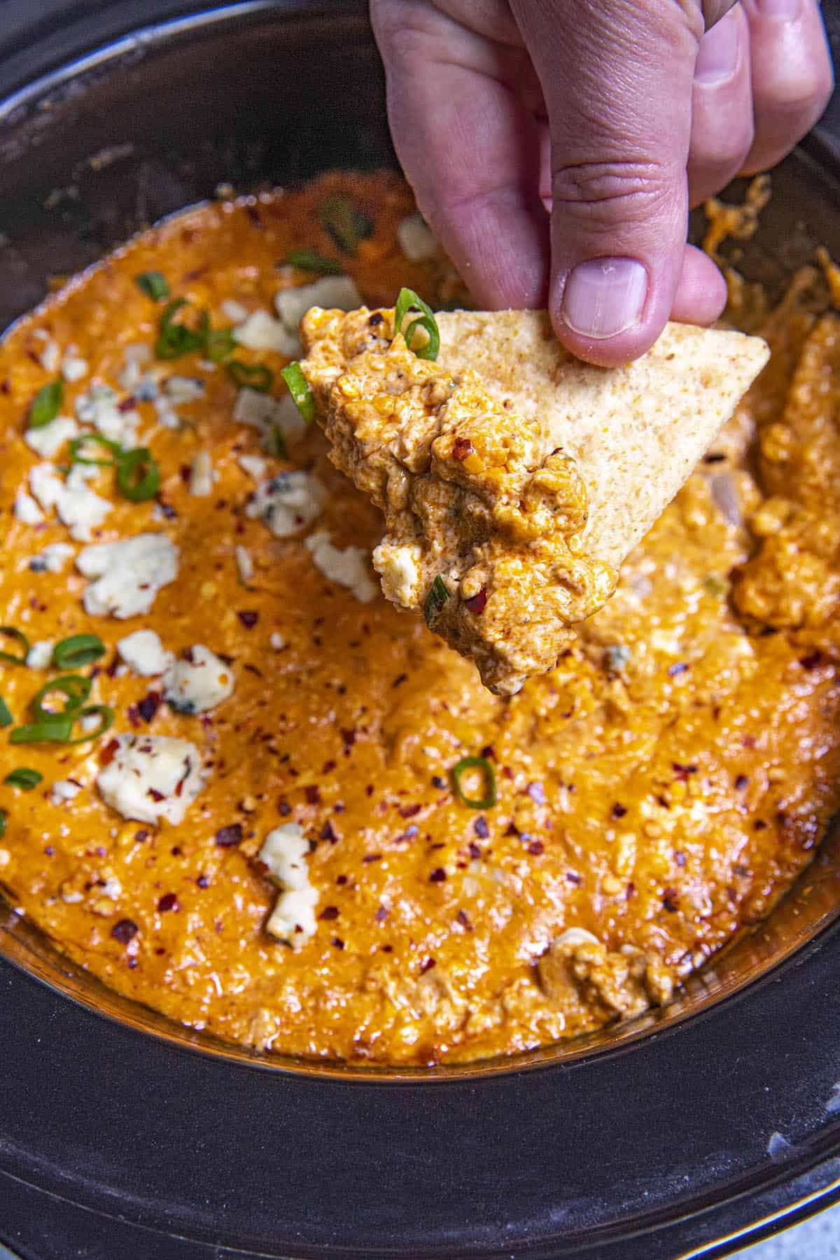Mike taking a scoop of Crockpot Buffalo Chicken Dip