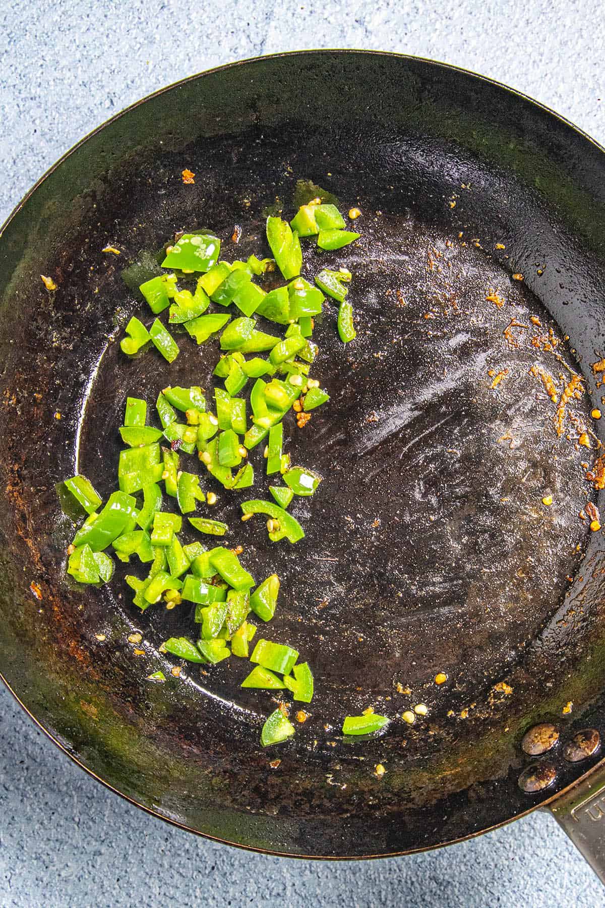 Cooking jalapeno pepper in a pan