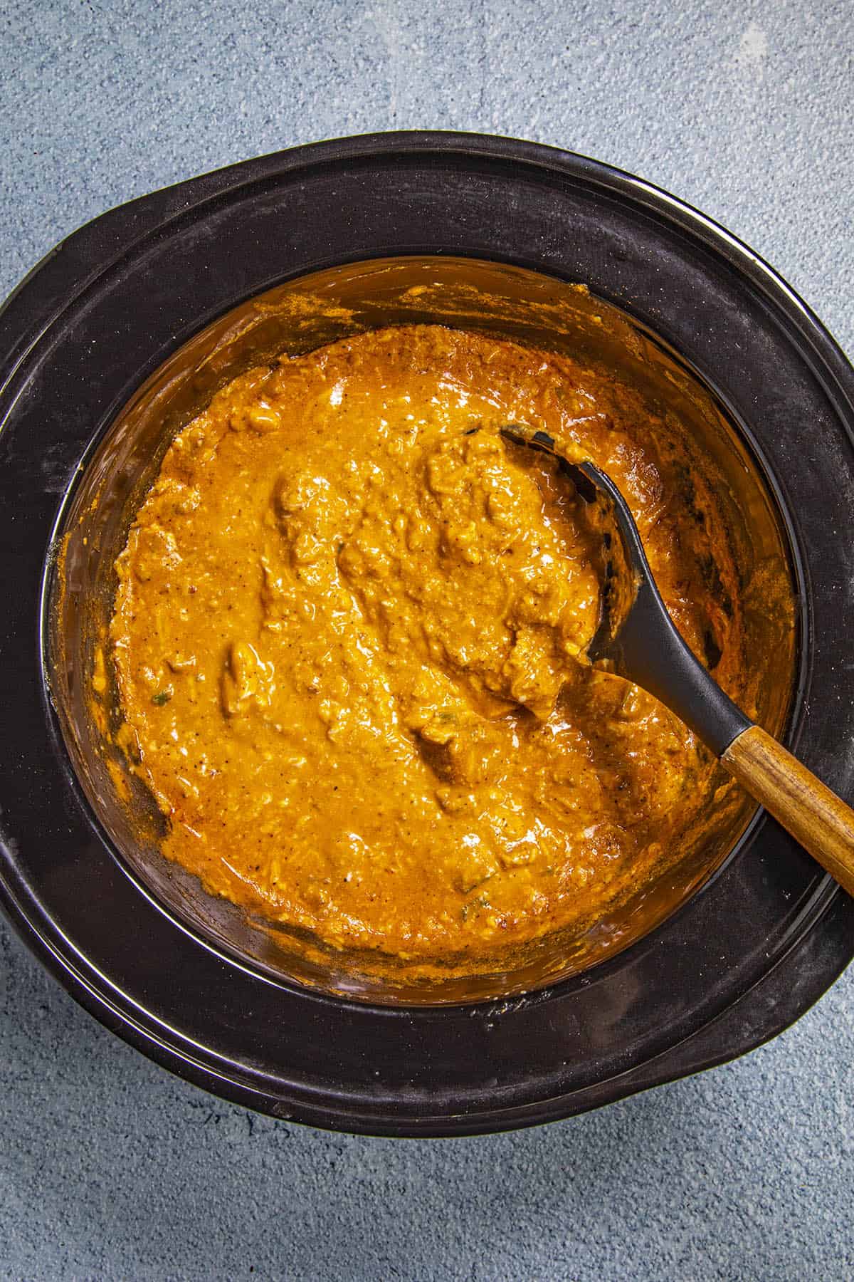 Stirring the Crockpot Buffalo Chicken Dip in the crockpot