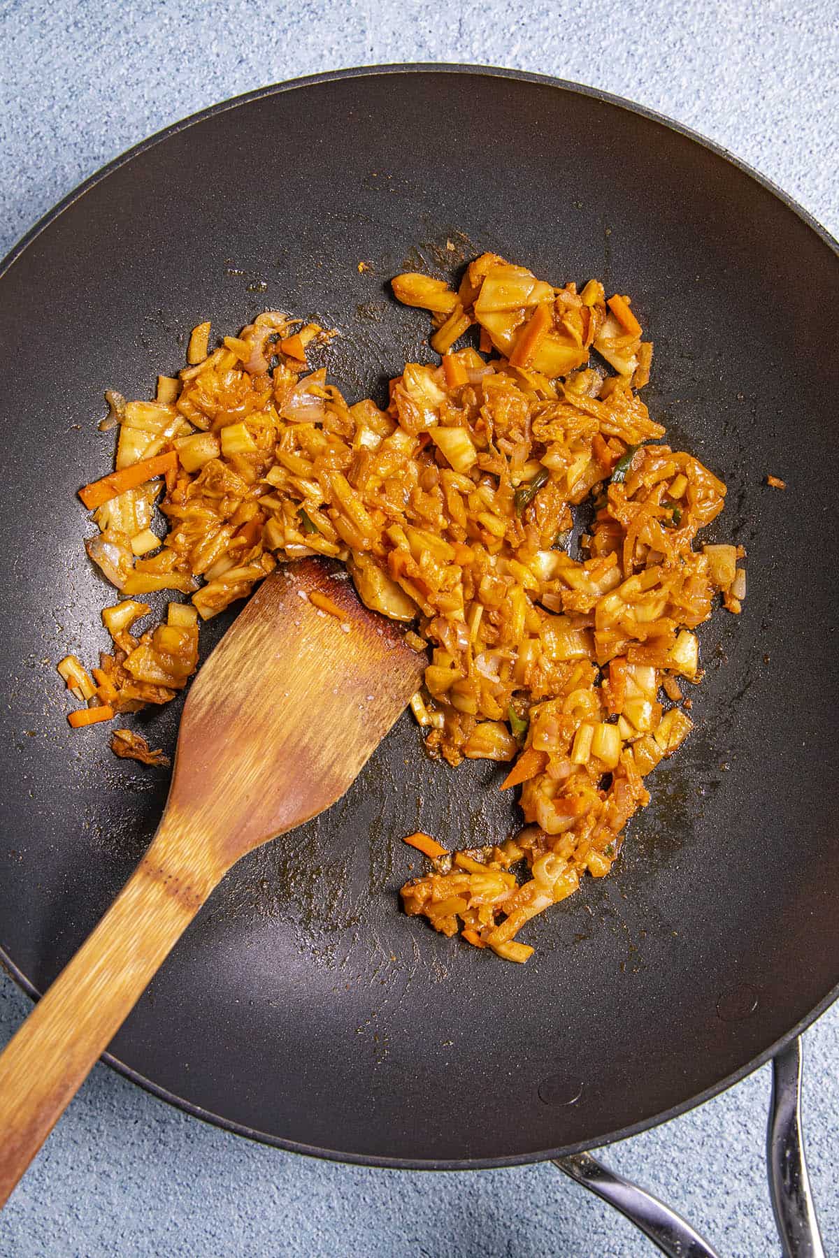 Stir frying the kimchi to make kimchi fried rice