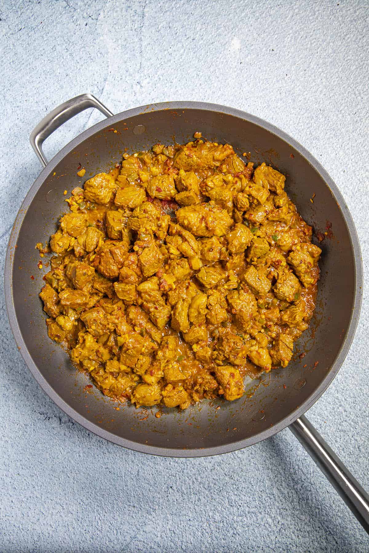 Cooking the marinated lamb in a hot pan to make Lamb Vindaloo