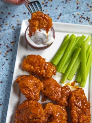 Mike dipping a Boneless Buffalo Wing into blue cheese dressing (or is it ranch?)