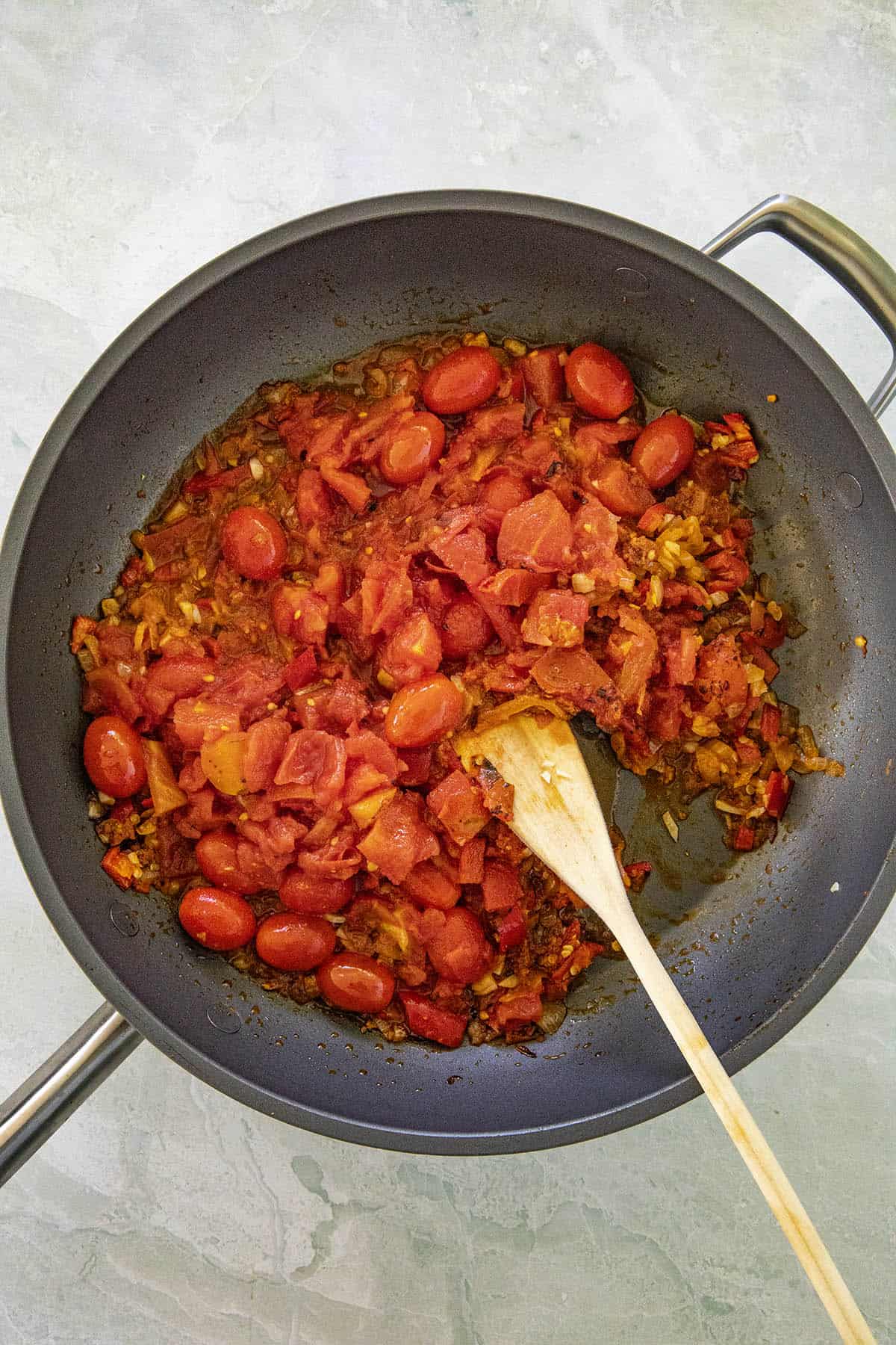 Mike stirring ingredients in a hot pan to make Arrabbiata Sauce