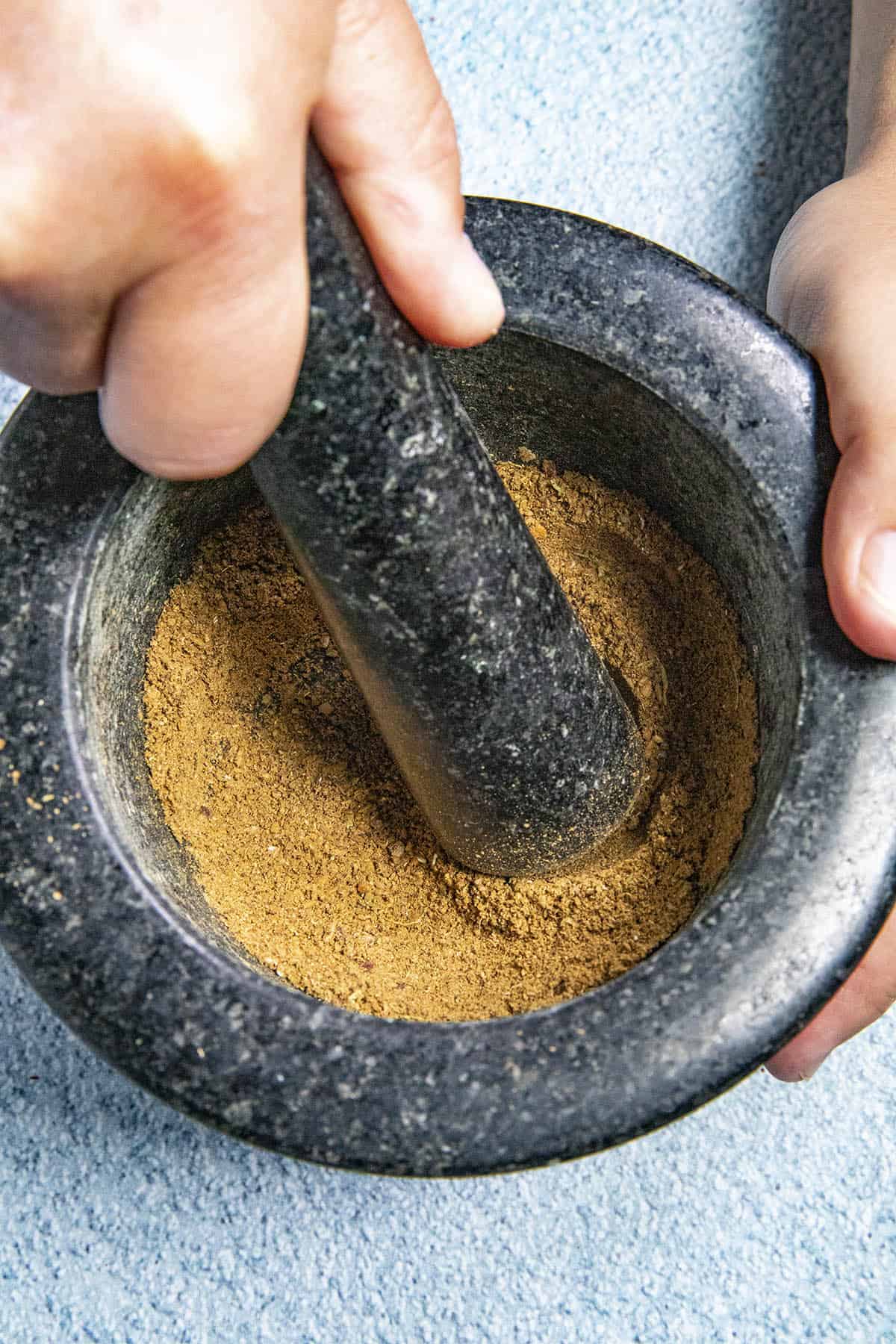 Grinding Garam Masala in a mortar