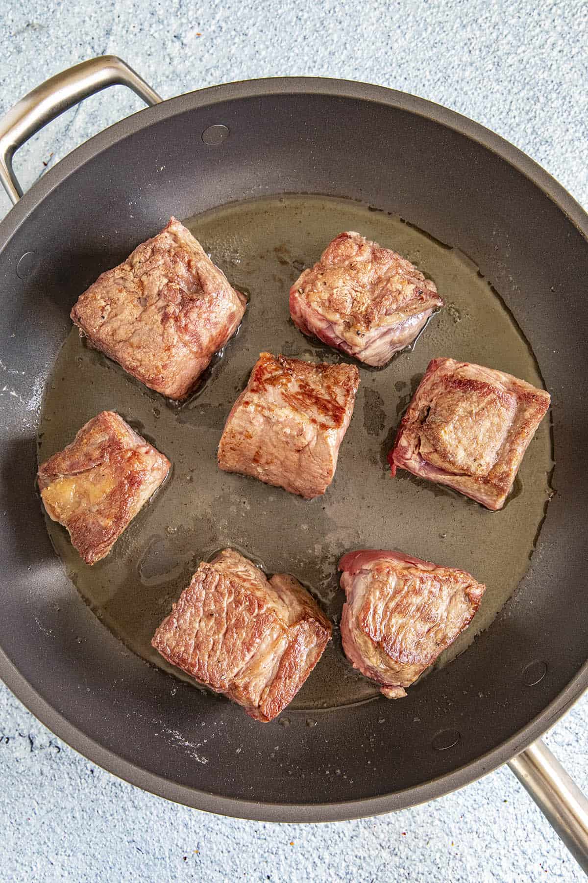 Browning the beef in a pan to make Mississippi Pot Roast