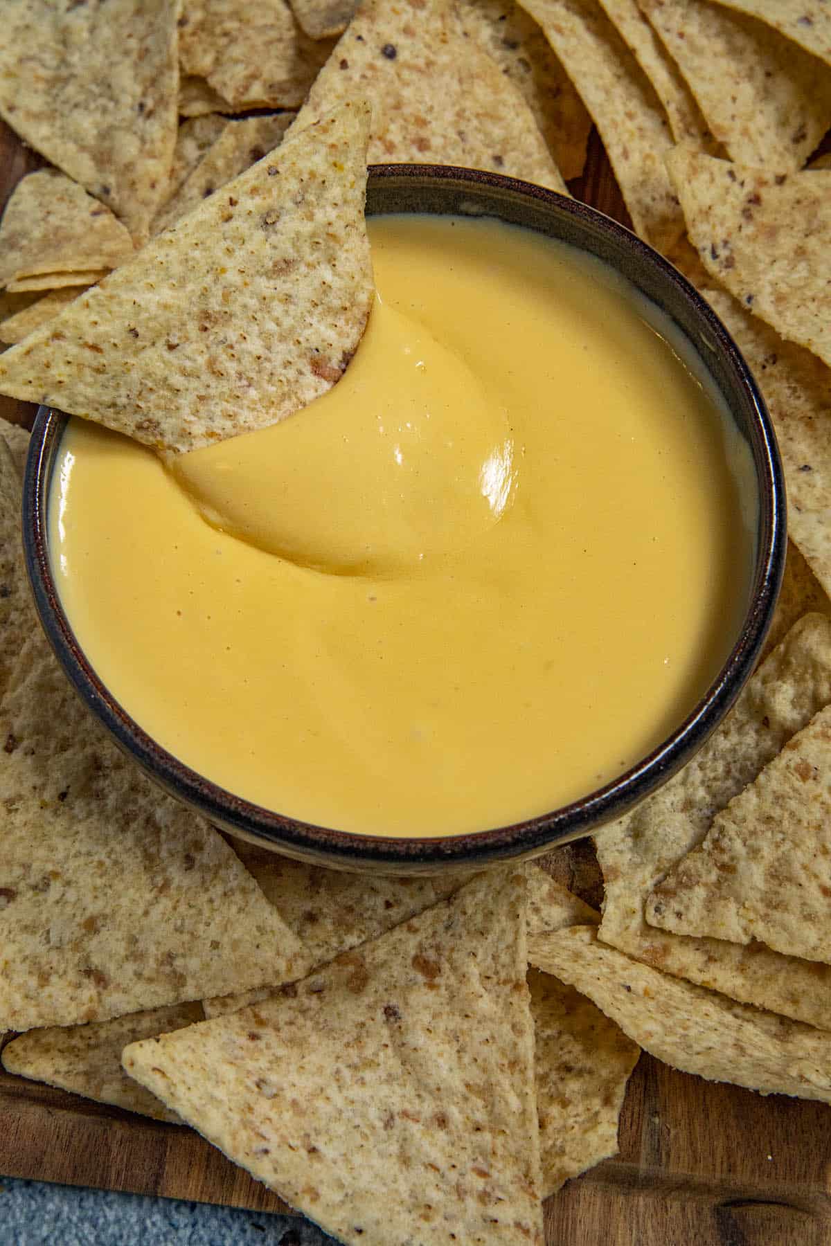 Spicy Nacho Cheese Sauce in a bowl with a tortilla chip