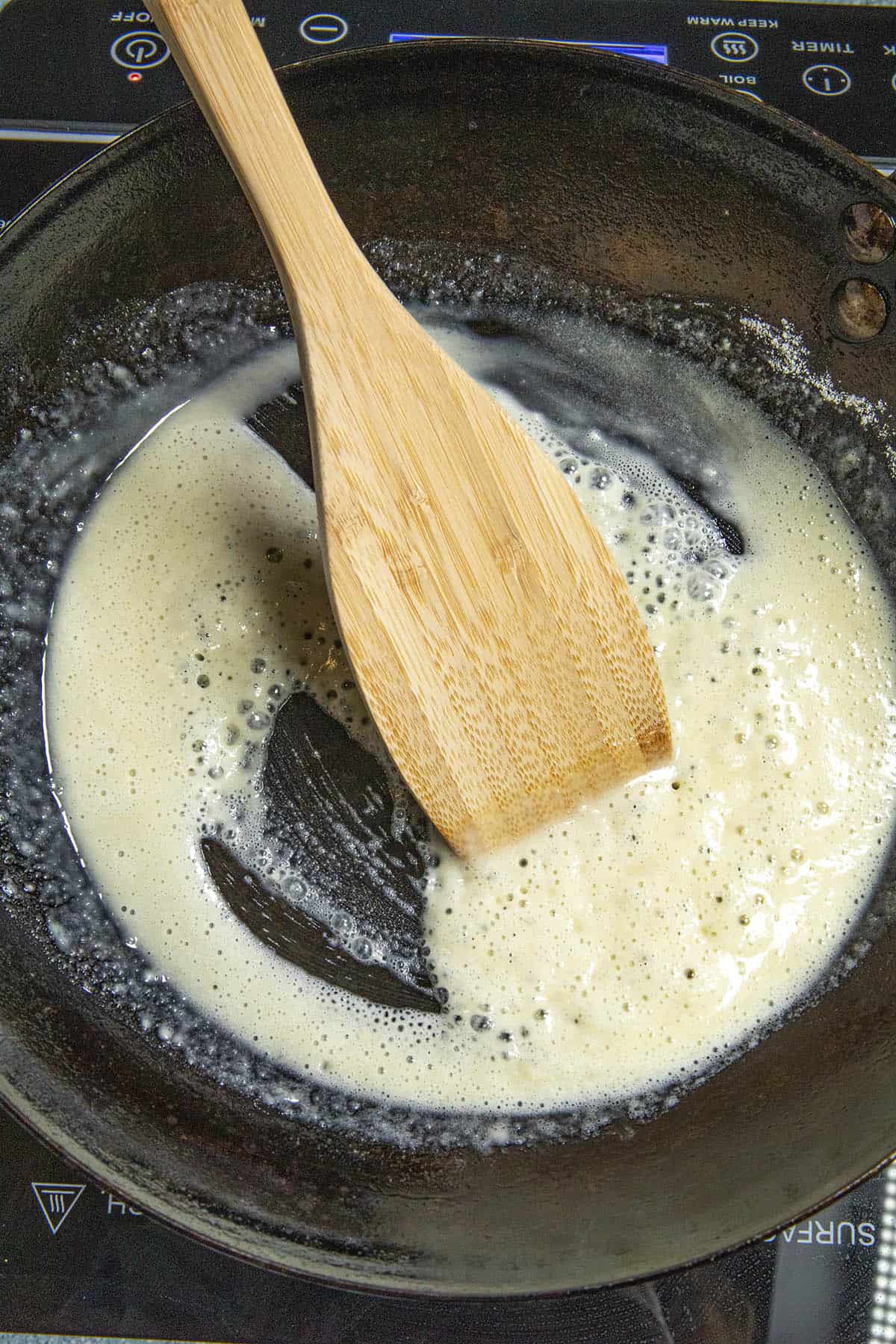 Stirring butter and flour to make a roux for homemade Nacho Cheese Sauce