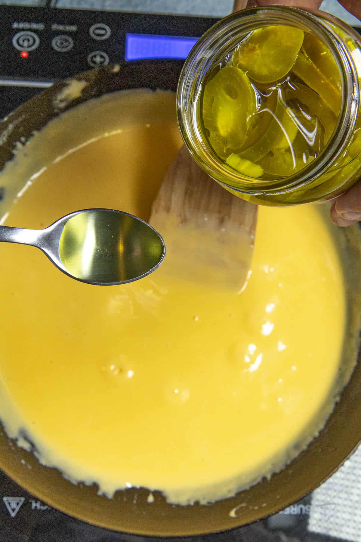 Adding jalapeno pickling juice to the homemade nacho cheese