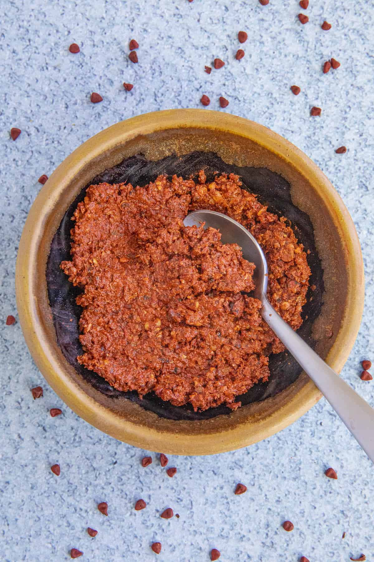 Achiote Paste in a bowl with a spoon, ready to use