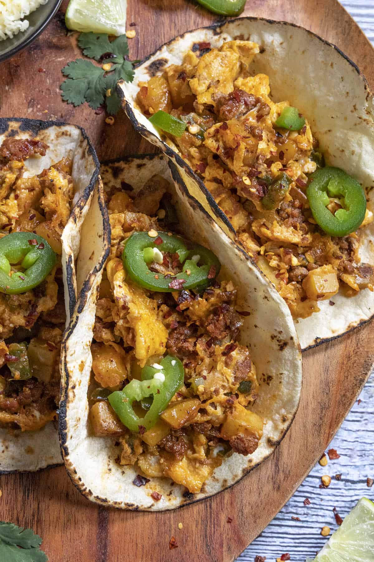 Three Spicy Breakfast Tacos on a platter with garnish