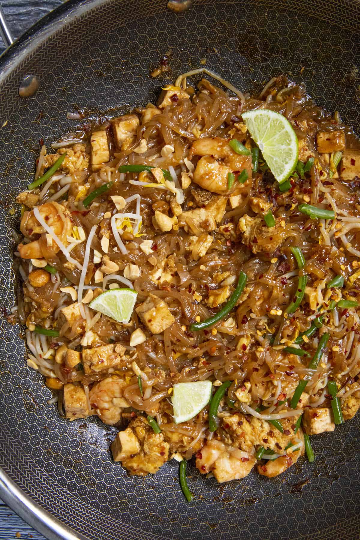 Spicy Pad Thai in a pan with garnish