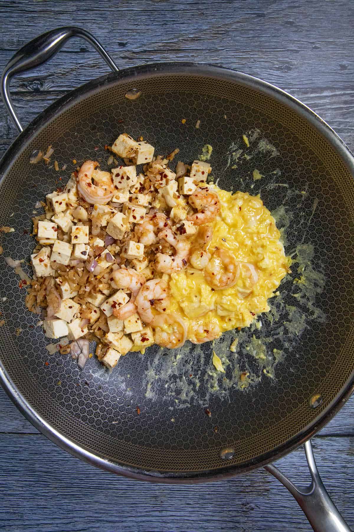 Stirring the eggs into the pan of Pad Thai