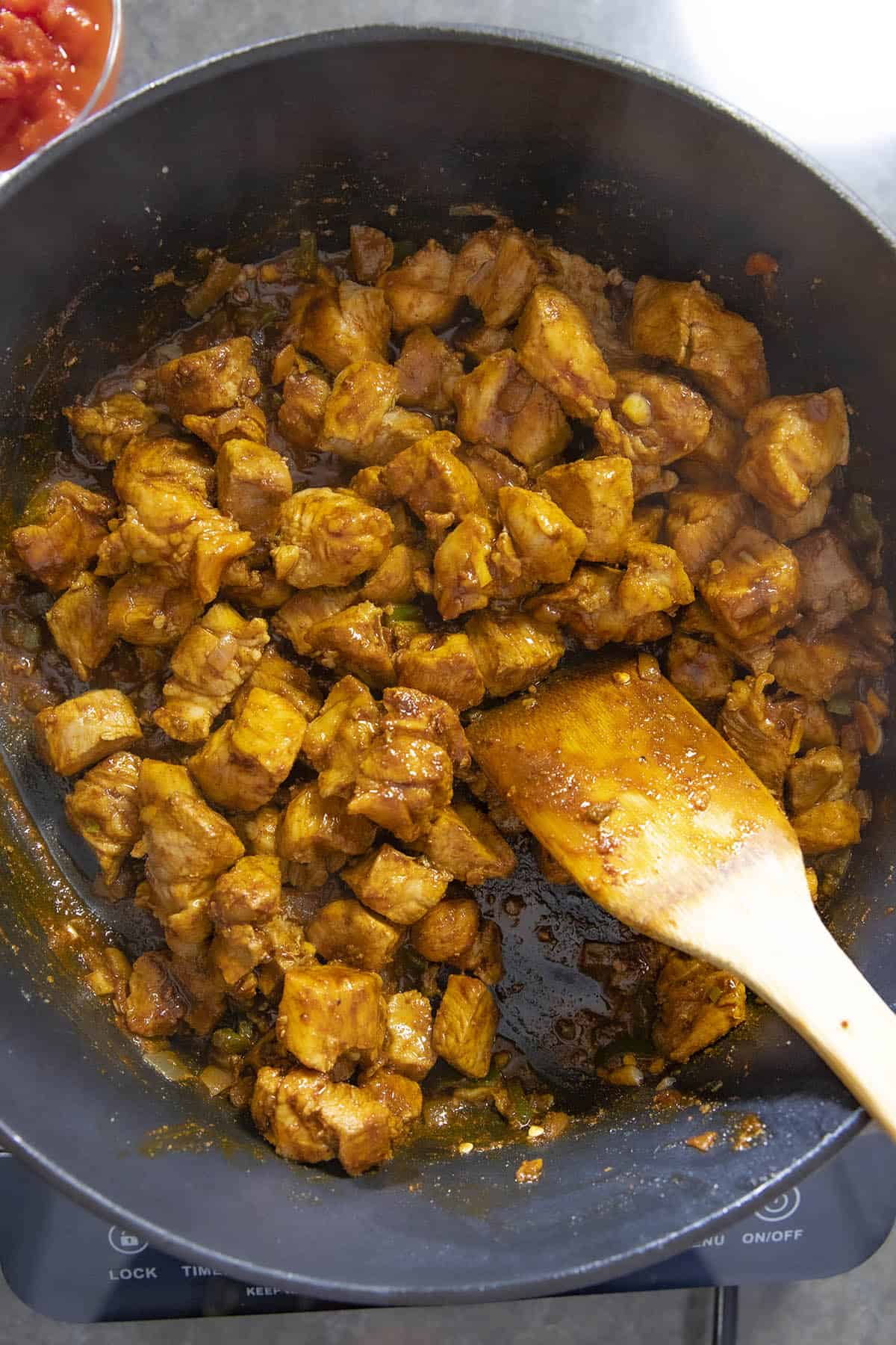 Adding seasonings to the browned pork shoulder