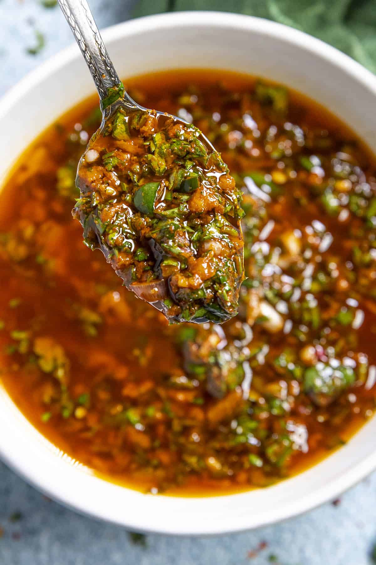 Spooning Chermoula sauce from the bowl