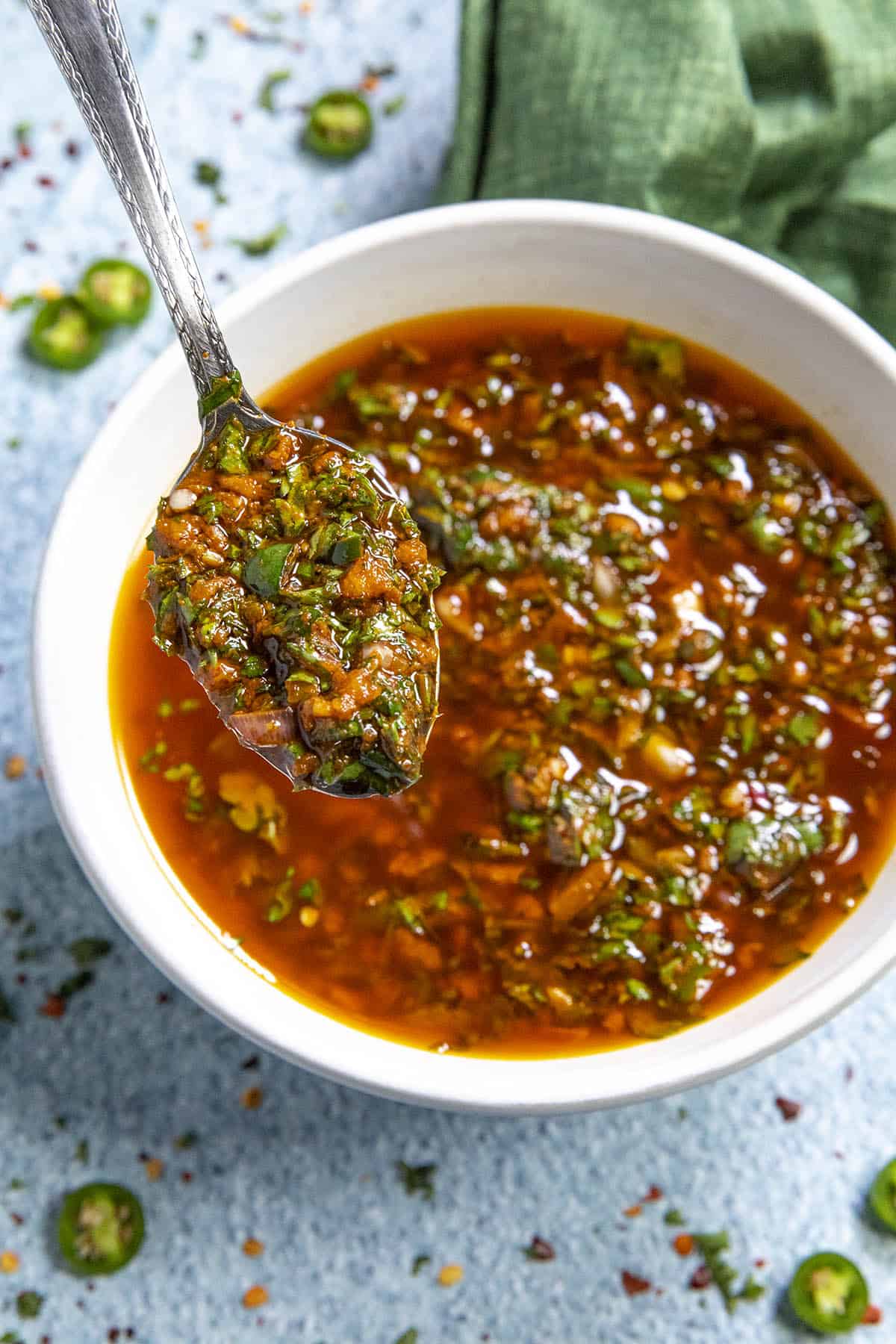 A spoonful of Chermoula sauce from a bowl