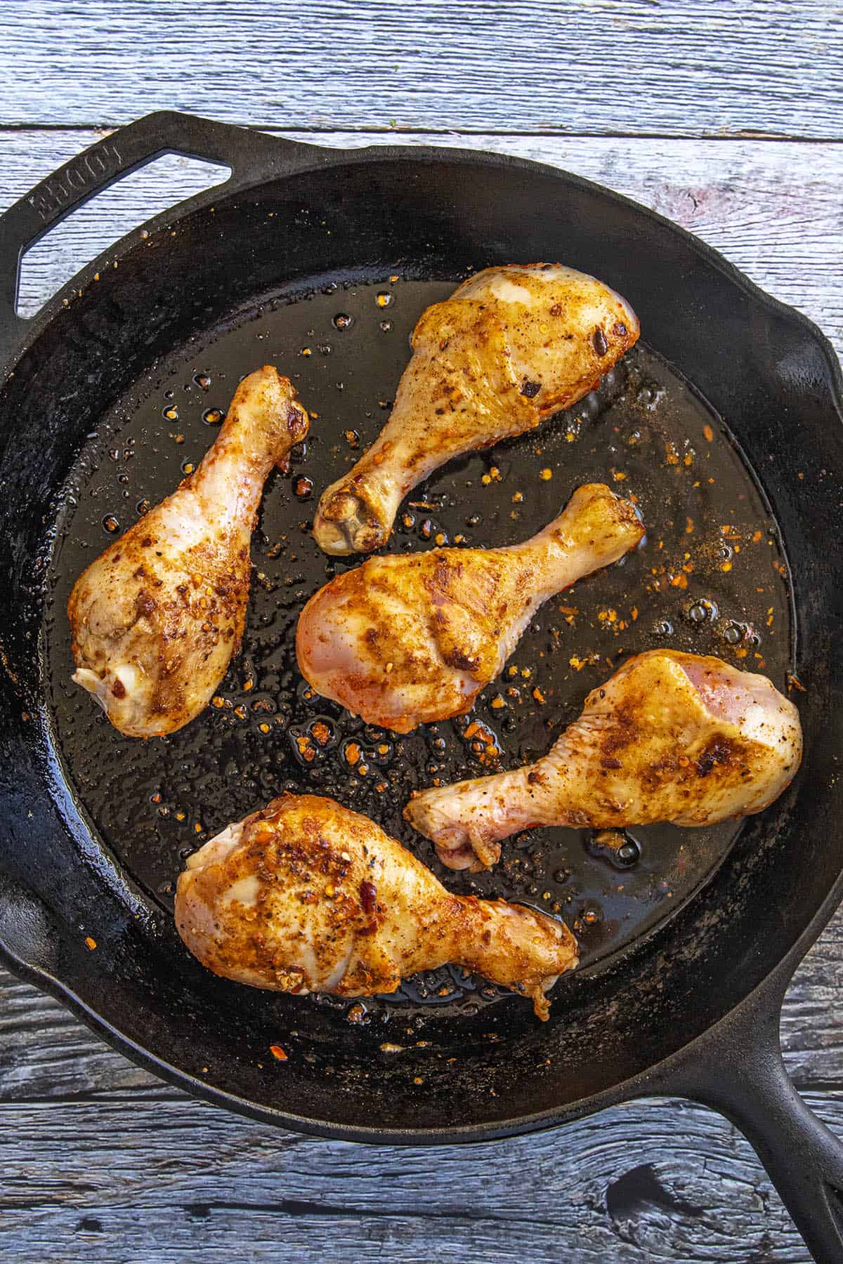 Searing Chicken Drumsticks in a hot pan