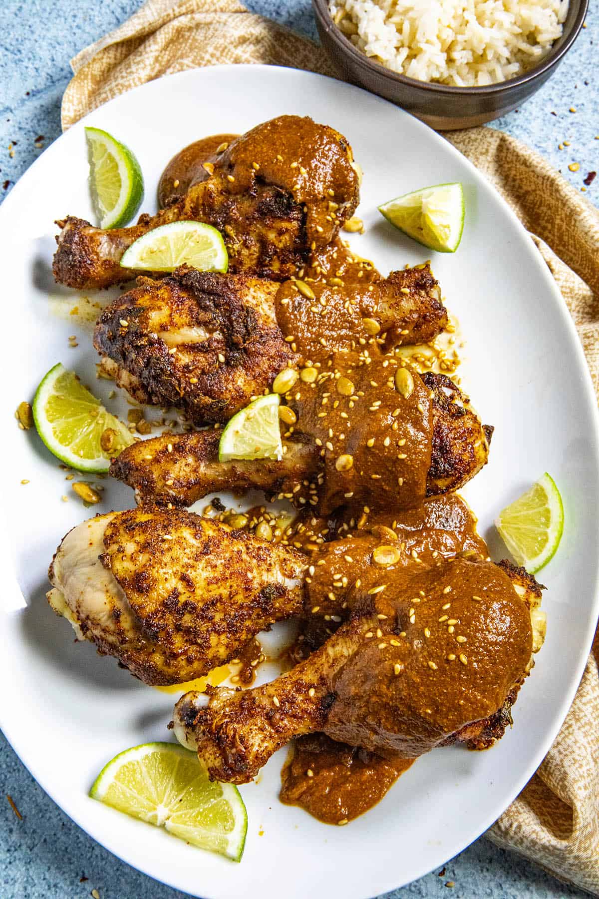 Chicken Drumsticks on a platter with Red Pipian Sauce