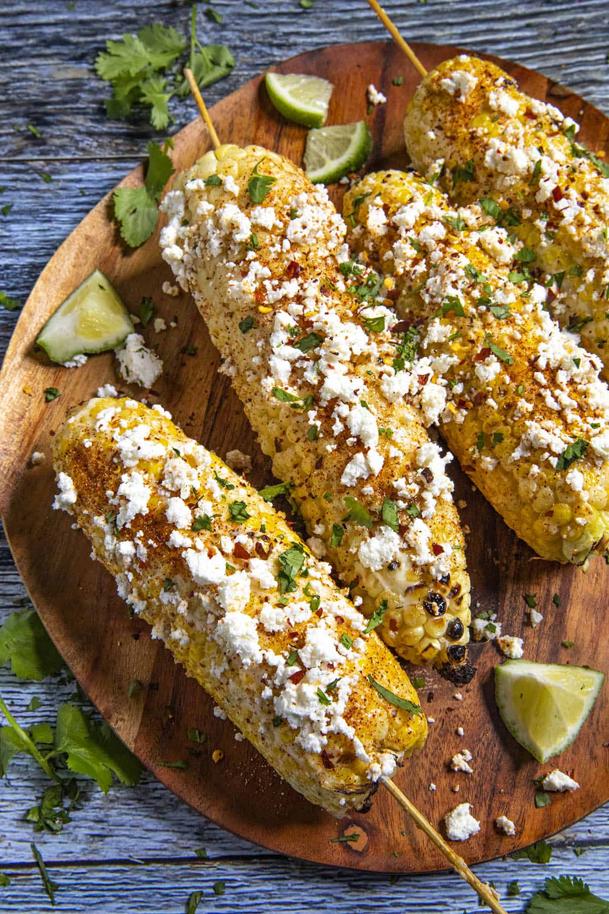 Elotes on a serving platter with lots of garnish