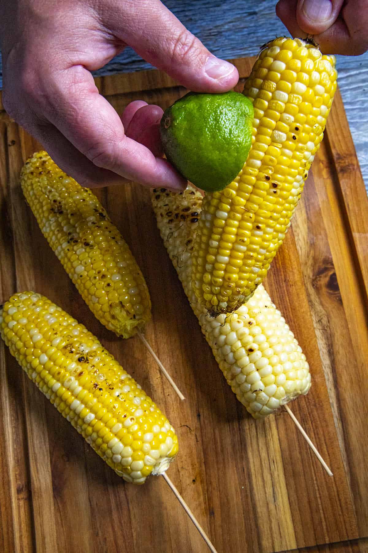 Coating the grilled corn with fresh lime