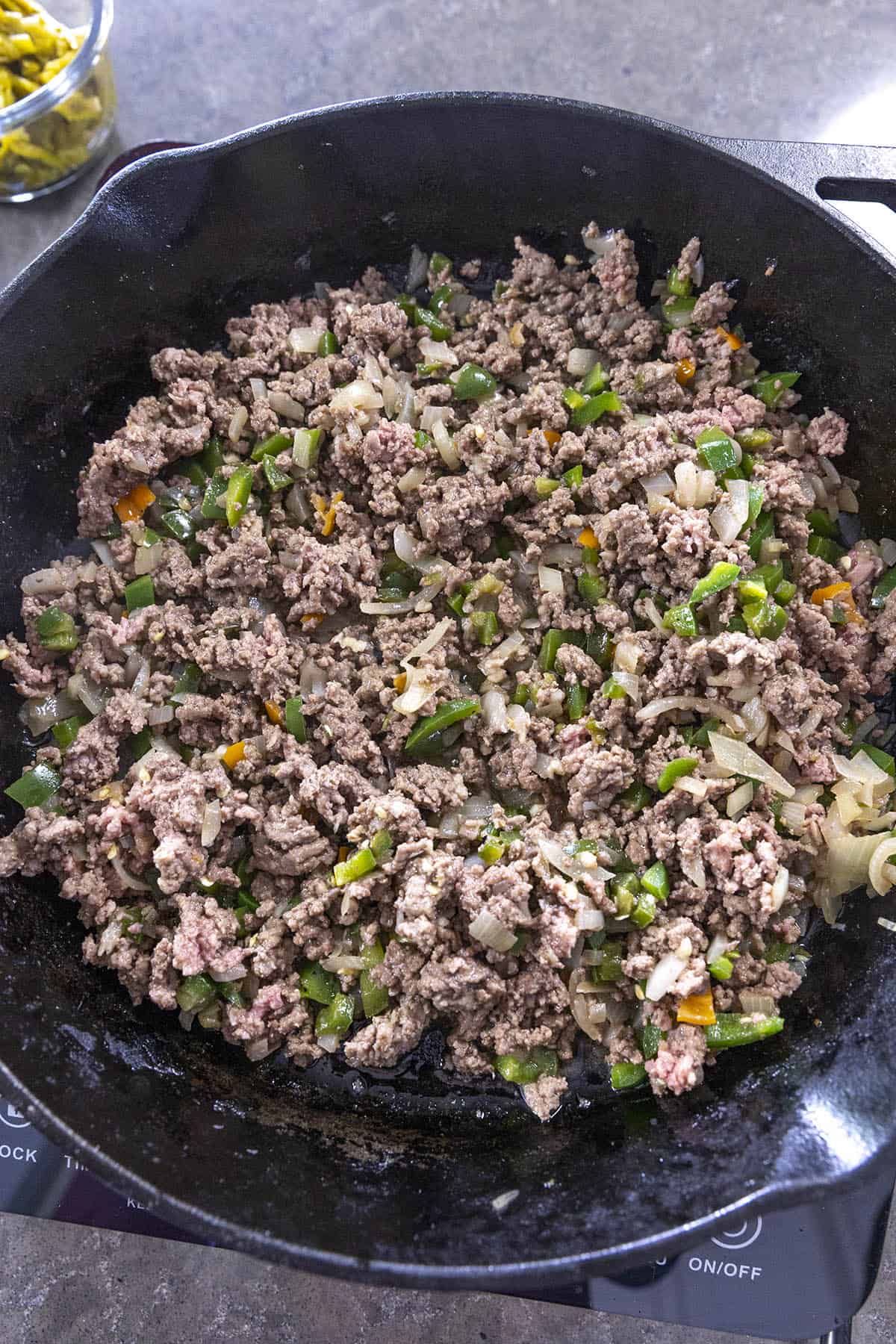 Browning the meat in a pan to make Chili Cheese Dip