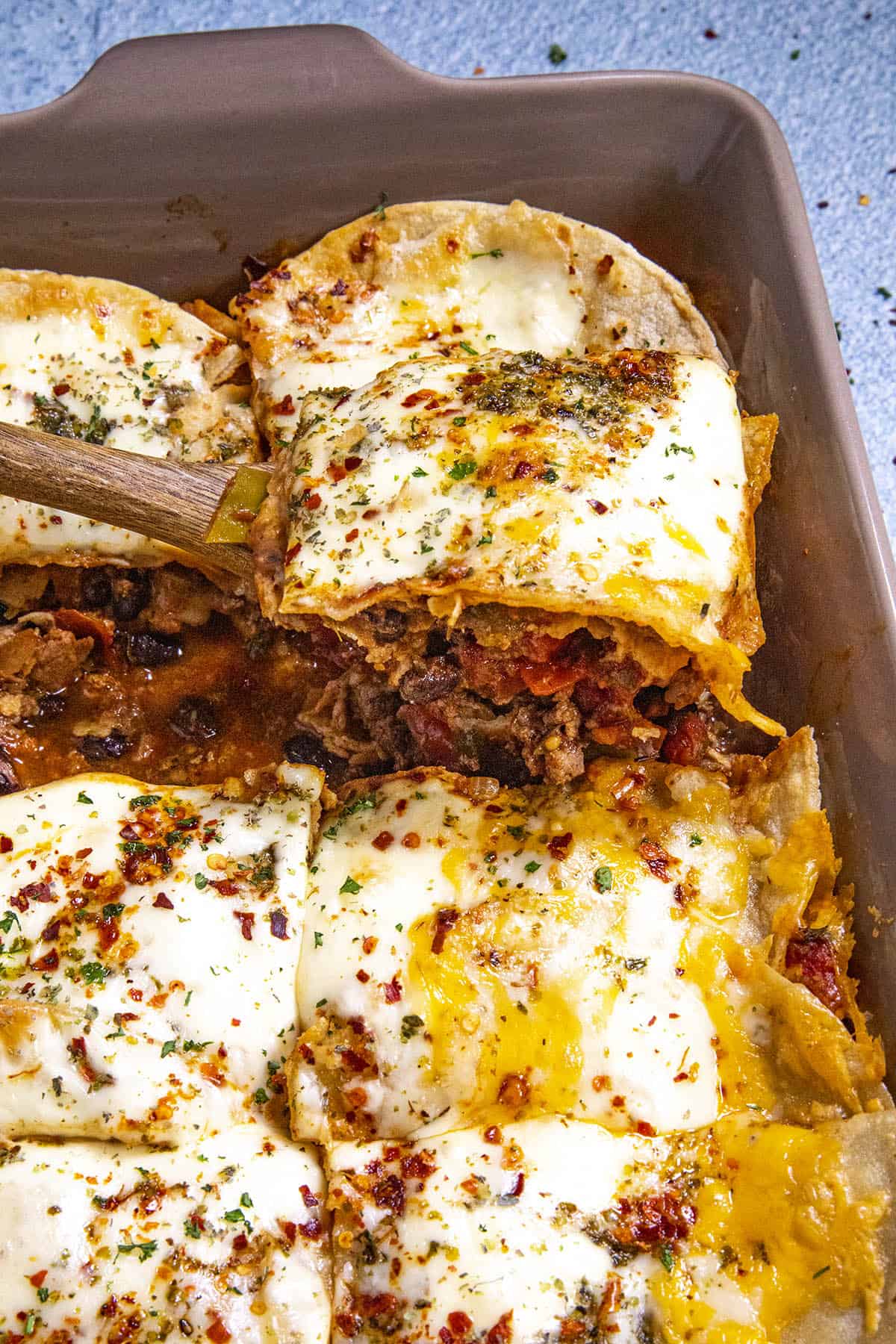 Mike serving a slice of Cheesy Mexican Lasagna