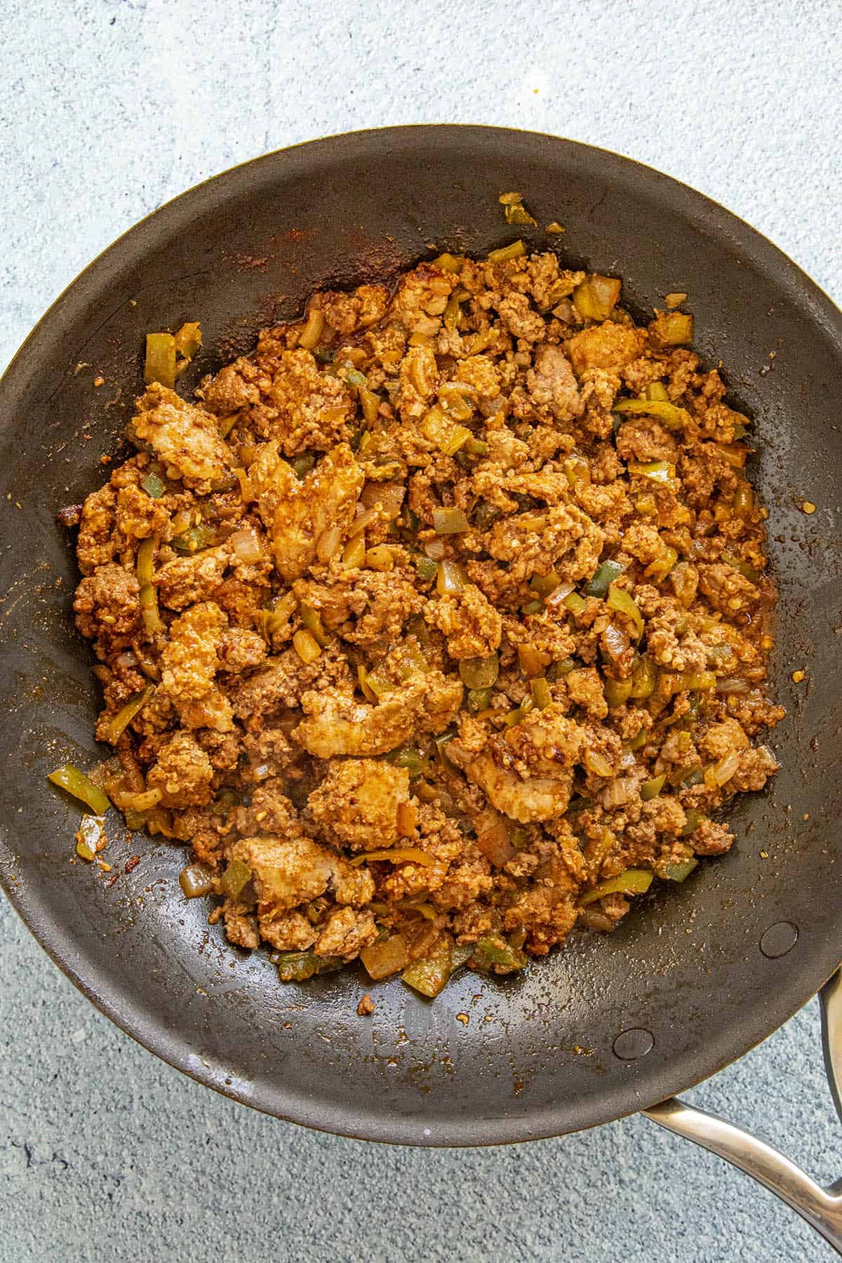 Cooked beef, vegetables, and spices in a pan