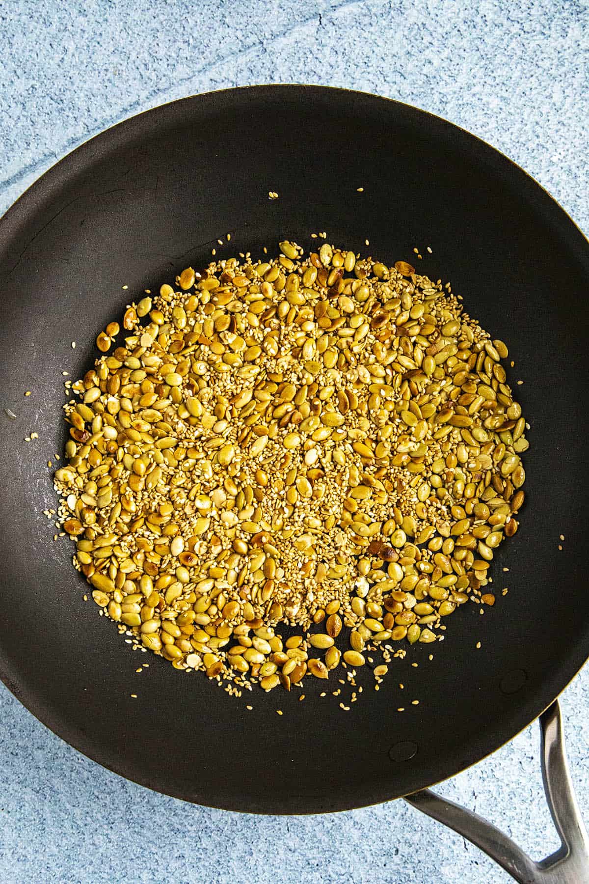 Toasting the nuts and seeds in a pan