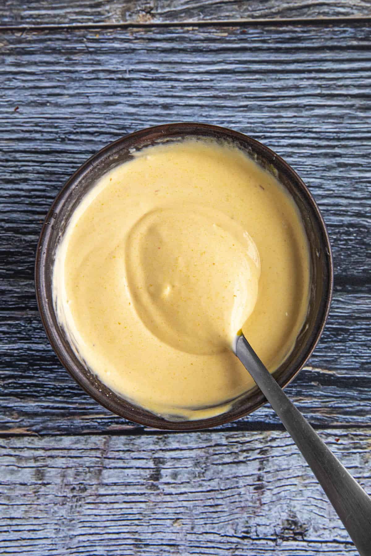 Aji Amarillo Sauce in a bowl for Salchipapas