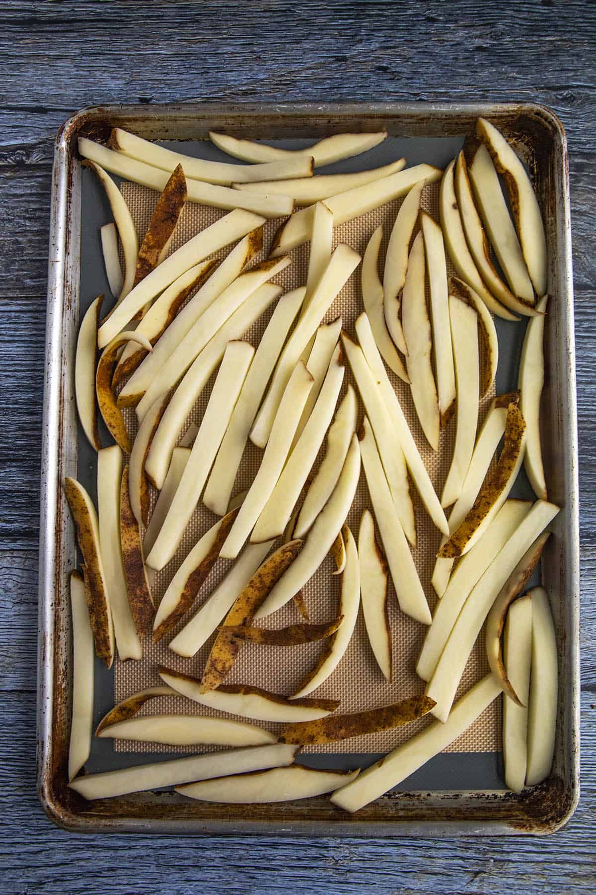 Sliced potatoes for making french fries, on a platter