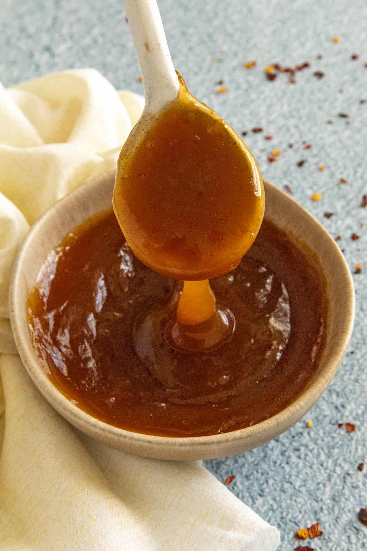 Sweet and Sour Sauce dripping from a spoon