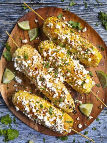 4 Elotes on a platter, ready to serve