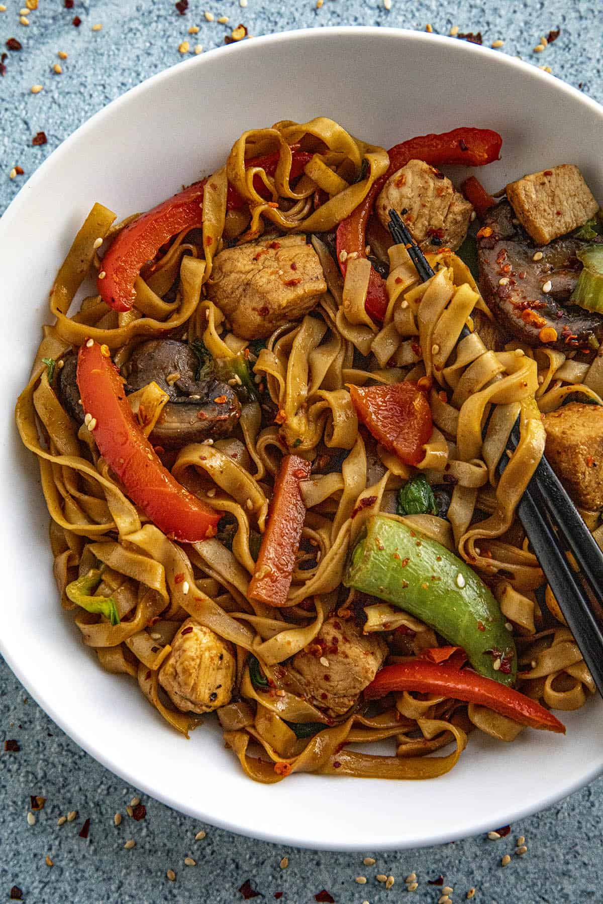 Mike taking a scoop of Chicken Lo Mein with chopsticks