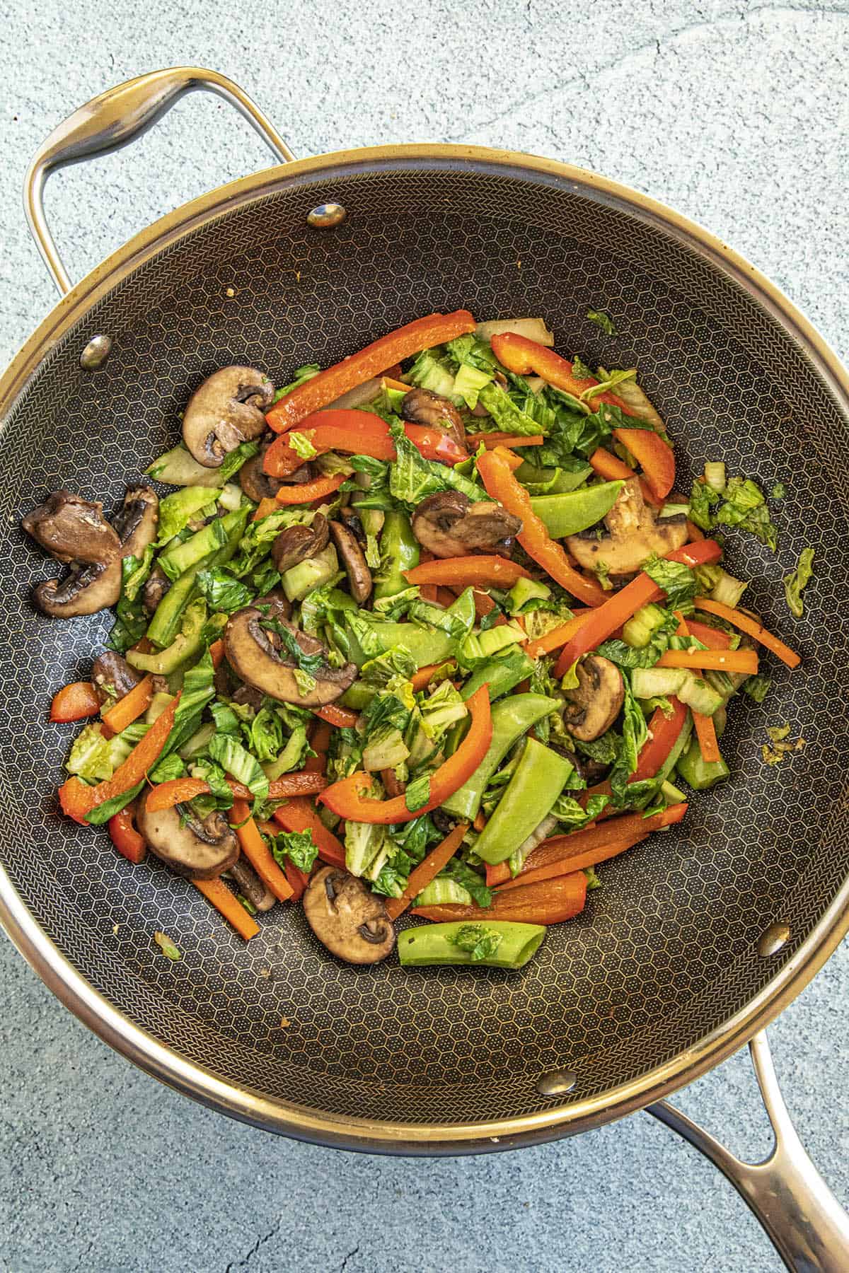 Stir frying the second round of vegetables in a hot pan