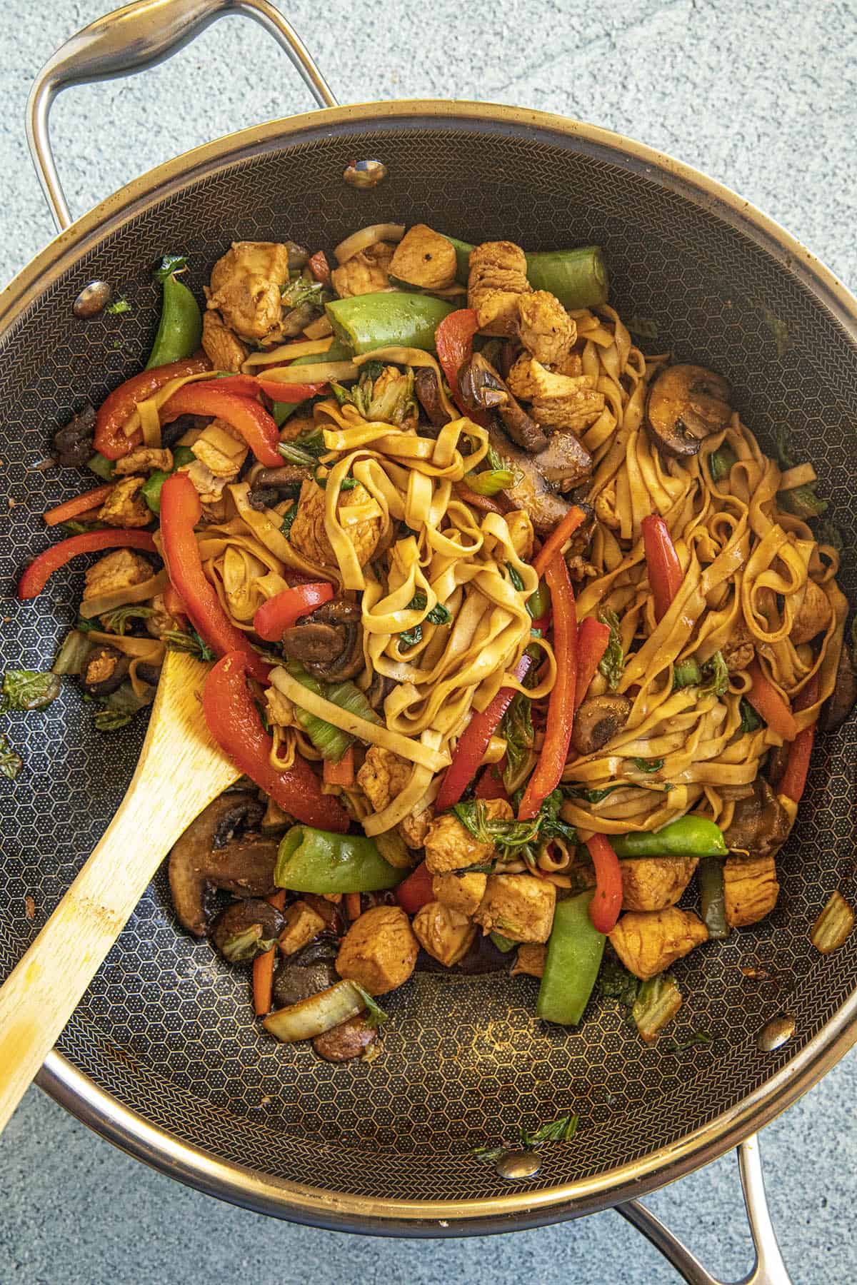Stirring together the Chicken Lo Mein in the pan